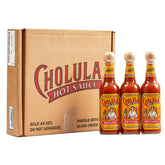 Cholula frente pack mostrando las tres botellas y la caja listos para regalar