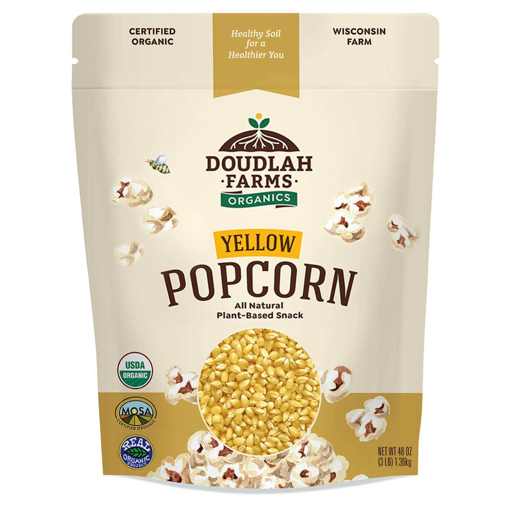 Doudlah Farms frente del paquete de palomitas amarillas orgánicas mostrando marca y peso