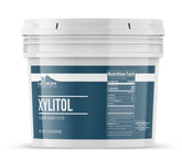 Earthborn Elements xylitol frente del envase mostrando bote de 1 galón y marca