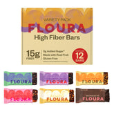 FLOURA paquete frontal mostrando caja de 12 barras y seis sabores, ideal para llevar