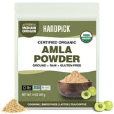 HANDPICK envase frontal del polvo de amla mostrando etiqueta clara y tamaño
