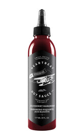 Heartbeat Hot Sauce Co. botella frente mostrando etiqueta y color frutal