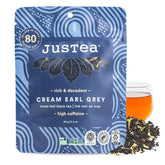 JusTea bolsa frente mostrando marca y rendimiento claro