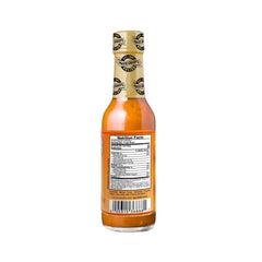 Marie Sharp's textura de la salsa mostrando pulpa de mango y cuerpo brillante