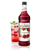 Monin jarabe de granada frontal botella mostrando color vibrante y uso profesional