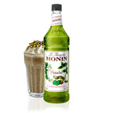 Monin jarabe de pistacho botella frontal mostrando color ámbar y marca Monin, ideal para cafés