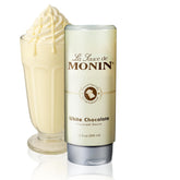Monin salsa de chocolate blanco botella frontal mostrando etiqueta y color cremoso
