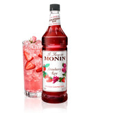 Monin botella frontal con jarabe fresa rosa y etiquetado claro, realza bebidas