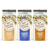 New England Coffee display frontal muestra las tres latas y variedad