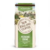 New England Coffee empaque frontal mostrando sabor pistachio crème y presentación atractiva