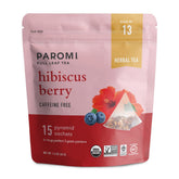 Paromi bolsa y taza con té hibiscus berry mostrando color rubí y aspecto apetecible