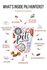 Pili Hunters mano sosteniendo pili nuts para comparar tamaño y escala real