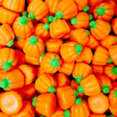 QUEEN CITY CANDY CAVE empaque frontal mostrando calabazas otoñales, ideal para fiestas