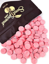 SweetGourmet bolsa frontal mostrando pastillas wintergreen rosadas y presentación práctica