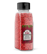 Unpretentious pimienta rosa frente en envase reutilizable, aporta sabor afrutado