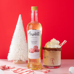 Amoretti botella junto a una regla mostrando la escala y cantidad útil