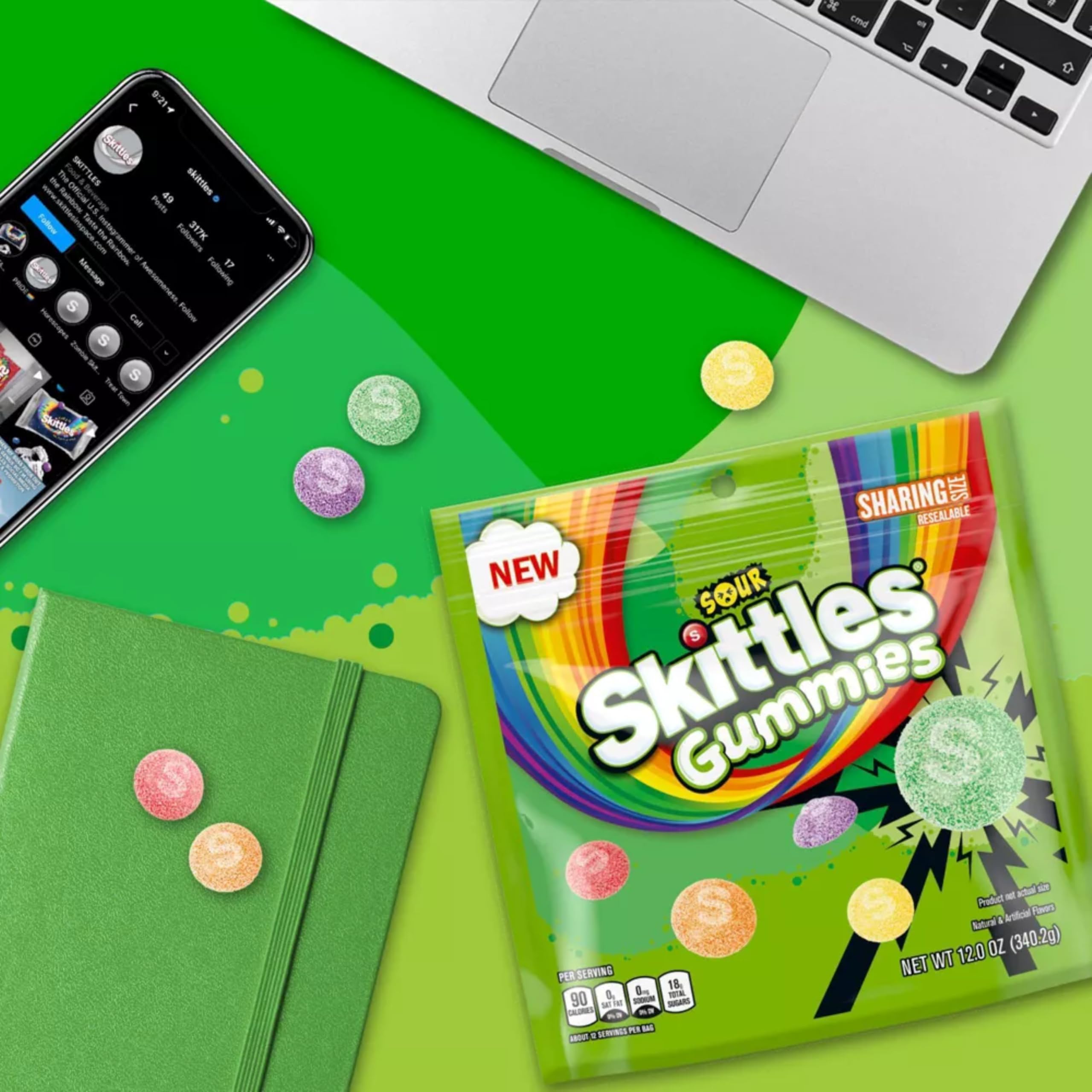 Assortit Skittles Sours comparación de tamaño junto a una mano para escala práctica