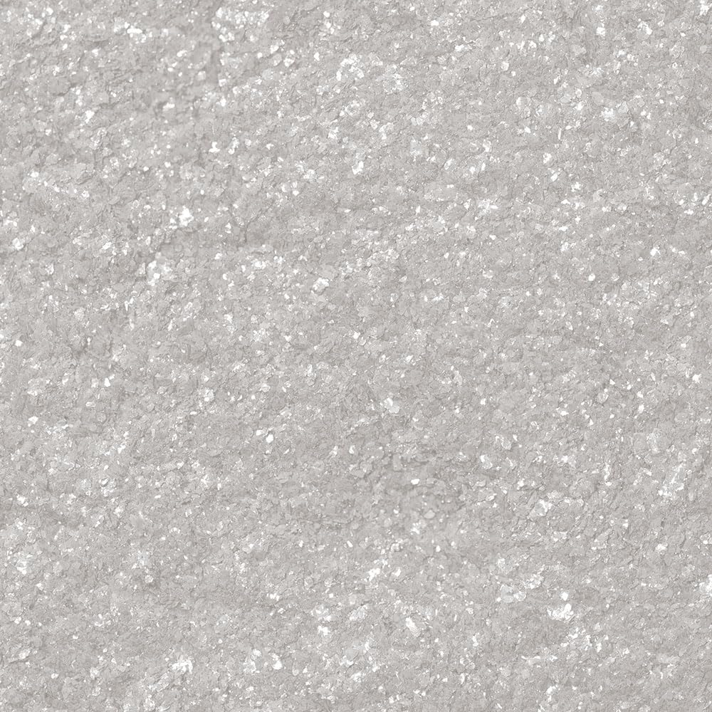Comparación de tamaño Bakell Tinker Dust blanco junto a utensilios repostería