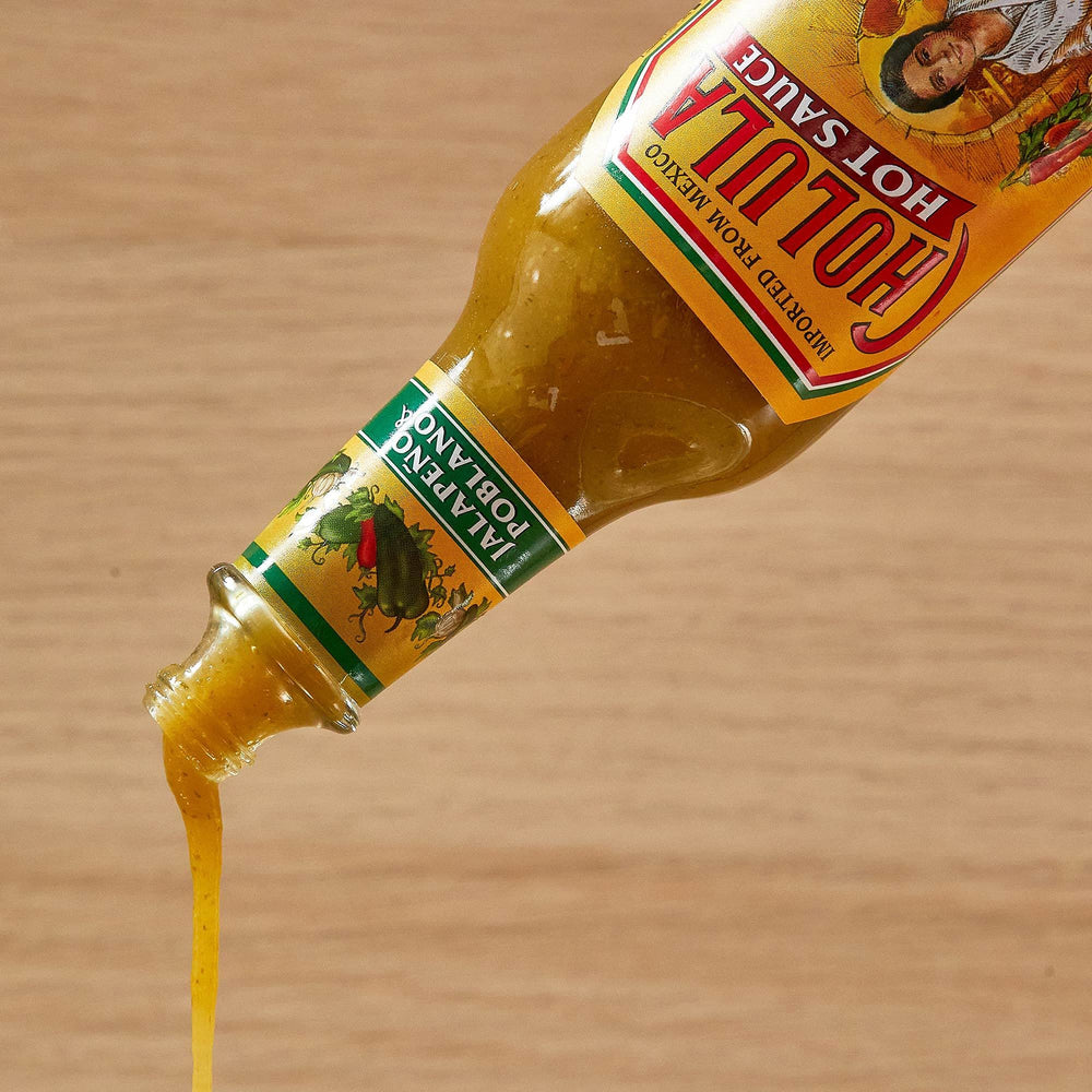 Cholula comparación de tamaño en mano mostrando escala práctica