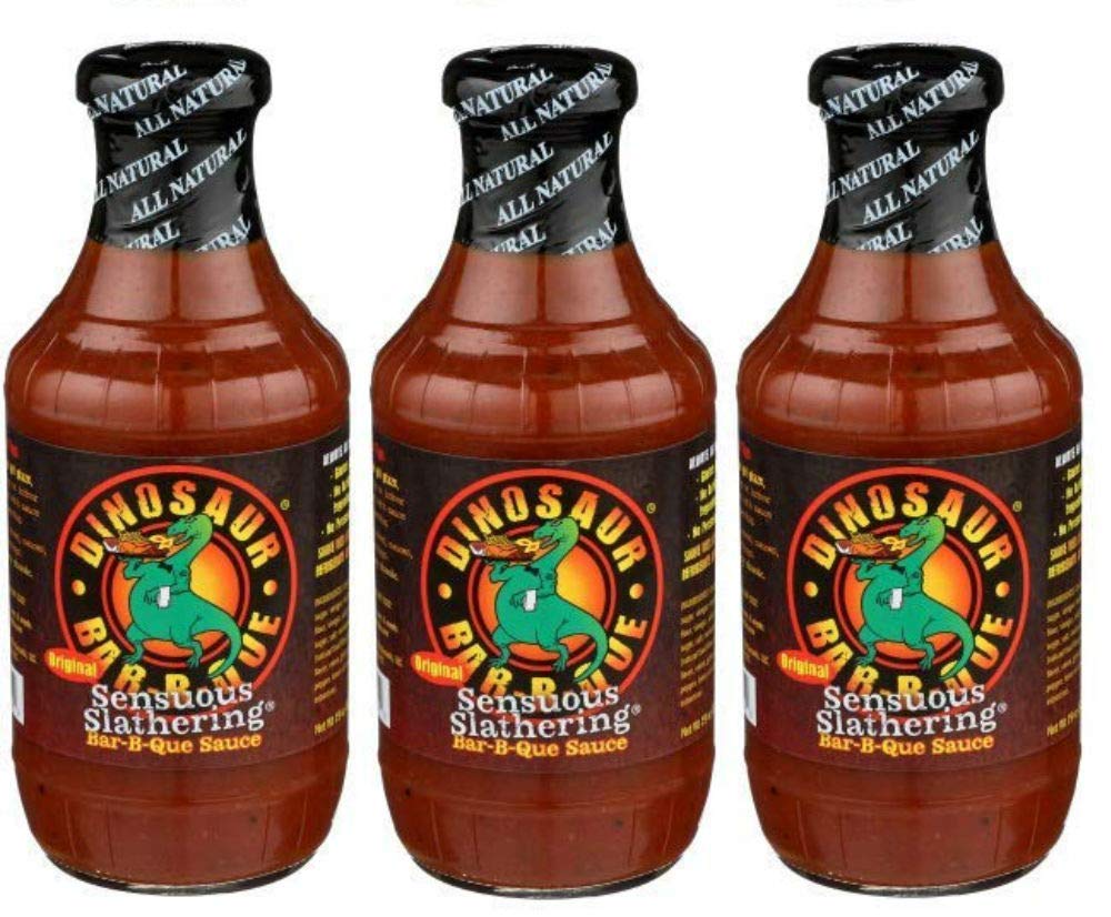 Dinosaur Bar-B-Que botella frontal mostrando etiqueta y textura cremosa para glasear