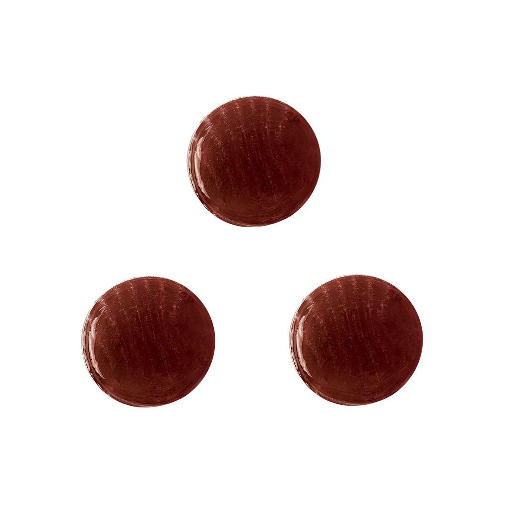 Dr. John's comparación de tamaño de caramelo junto a una moneda para escala