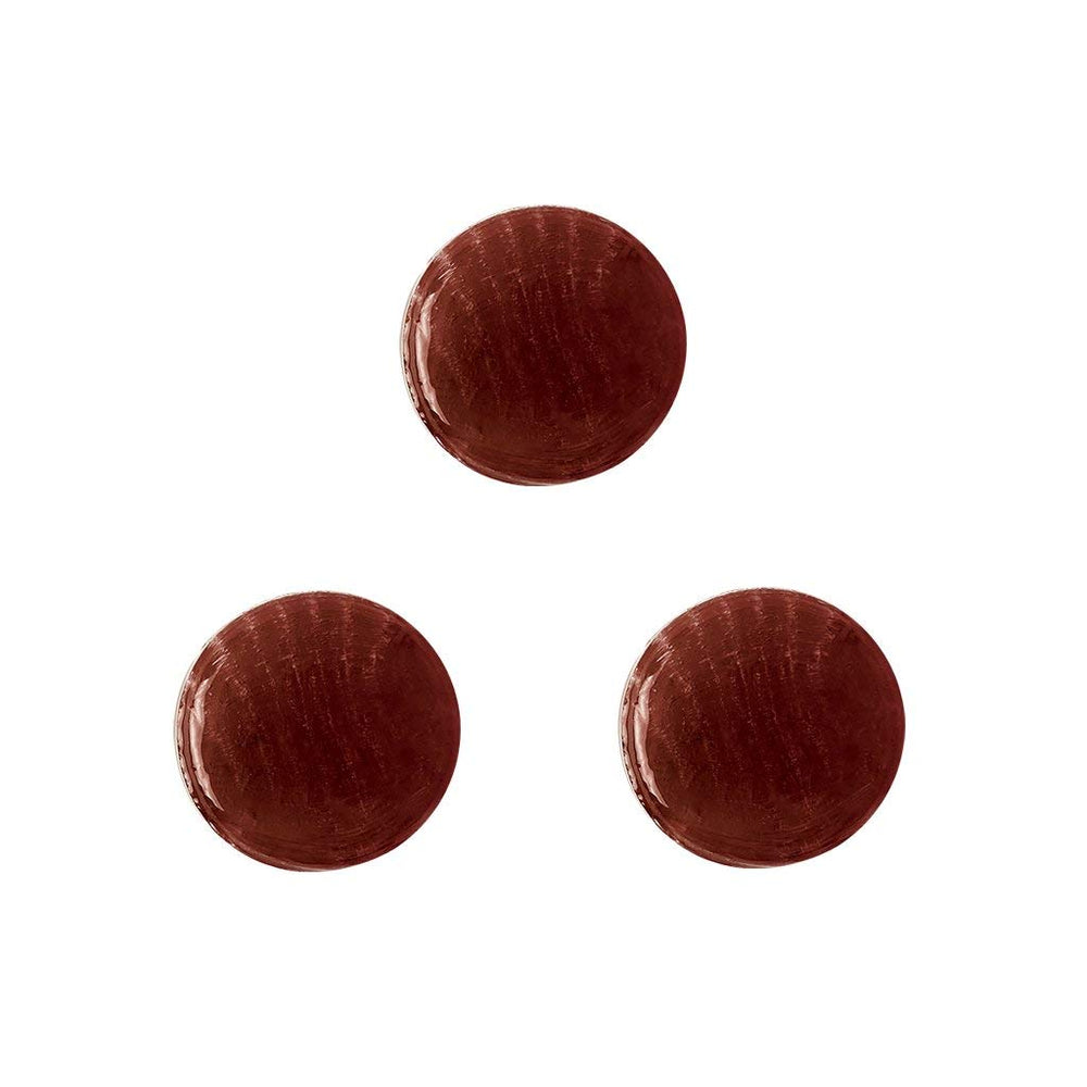 Dr. John's comparación de tamaño de caramelo junto a una moneda para escala
