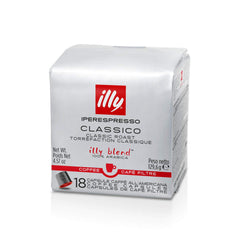 illy cápsula colocada en una máquina ily iperEspresso durante extracción, taza lista