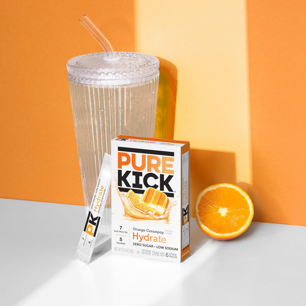 PURE KICK polvo naranja cremoso en cuchara destacando textura y sabor