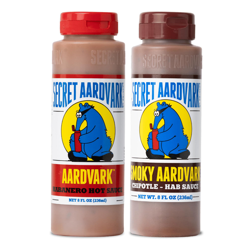 Secret Aardvark dos botellas frente mostrando etiqueta y diseño, ideal para condimentar