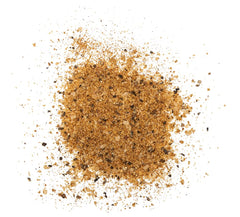 Weavers Steak Dust frasco sostenido en mano mostrando tamaño práctico para cocina